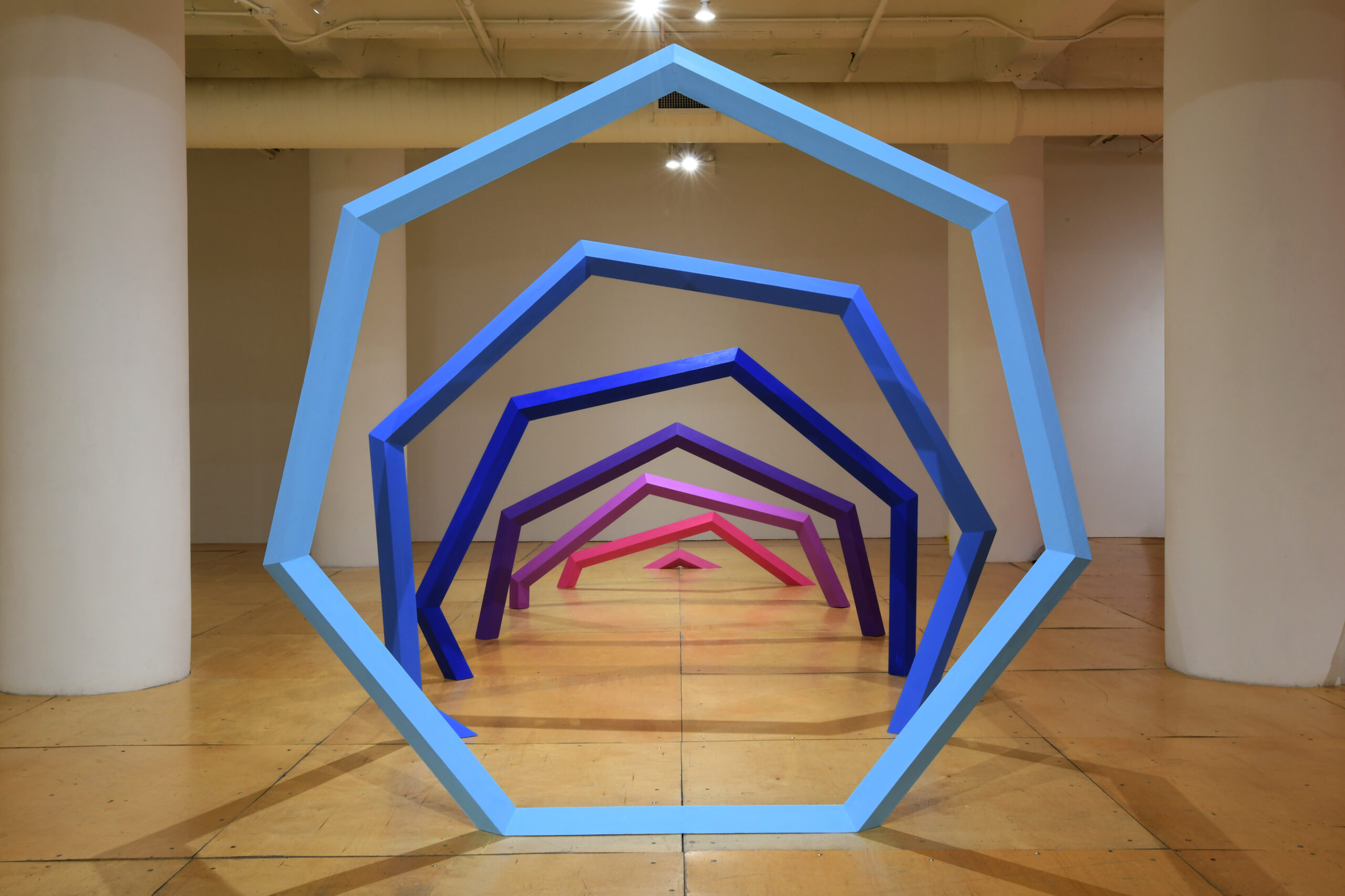 a sculptural portal formed from seven heptagonal rings